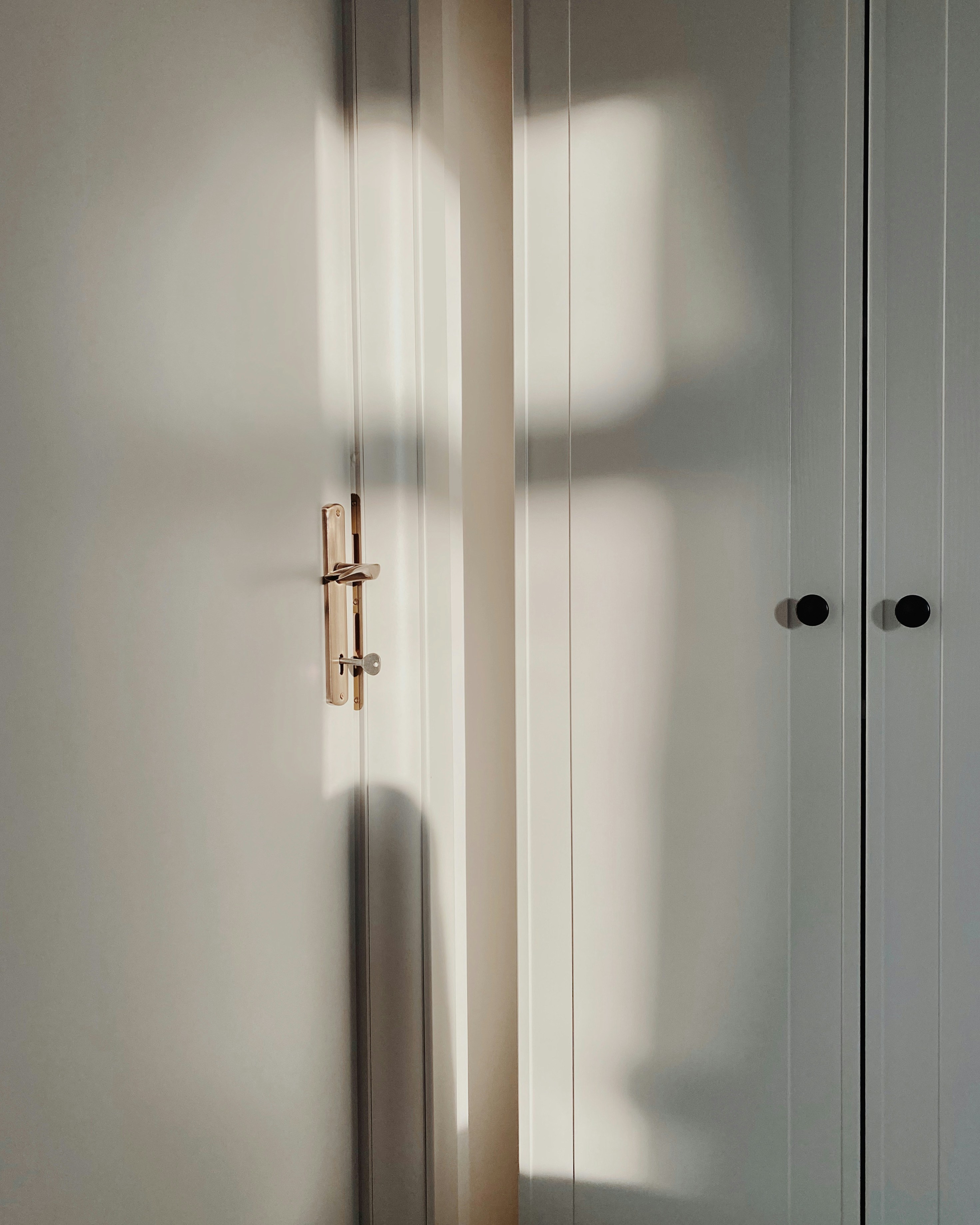 a white closet with a door and a window
