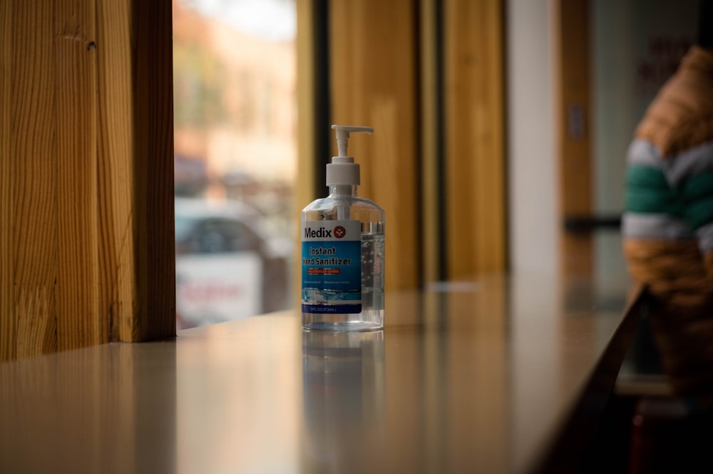 a bottle of hand sanitizer sitting on a counter