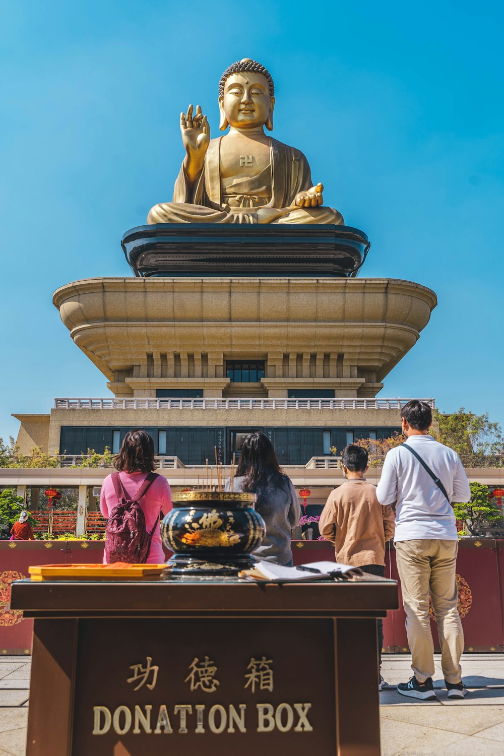 a group of people standing in front of a statue