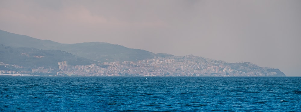 a large body of water with a city in the background