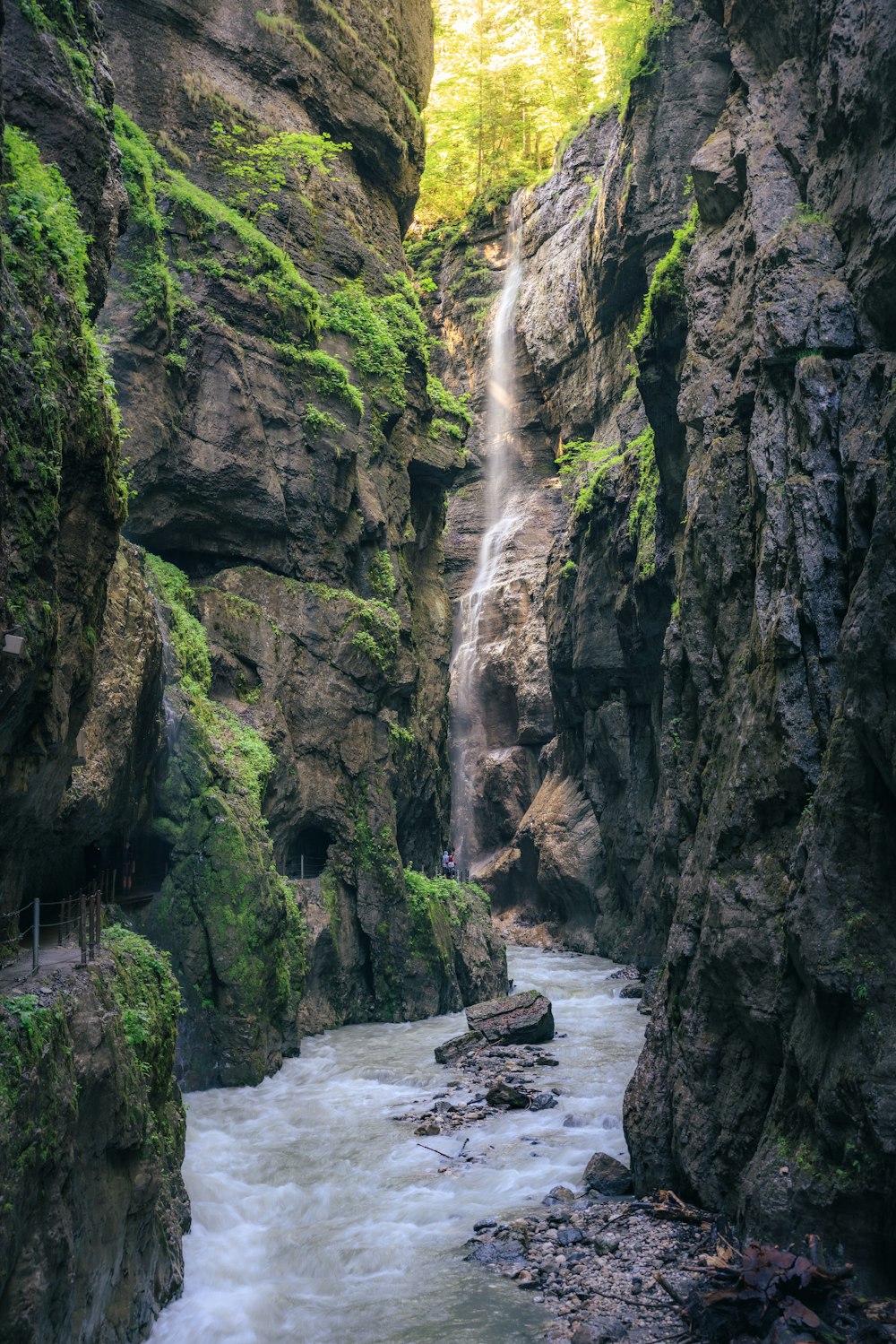 a waterfall in the middle of a canyon