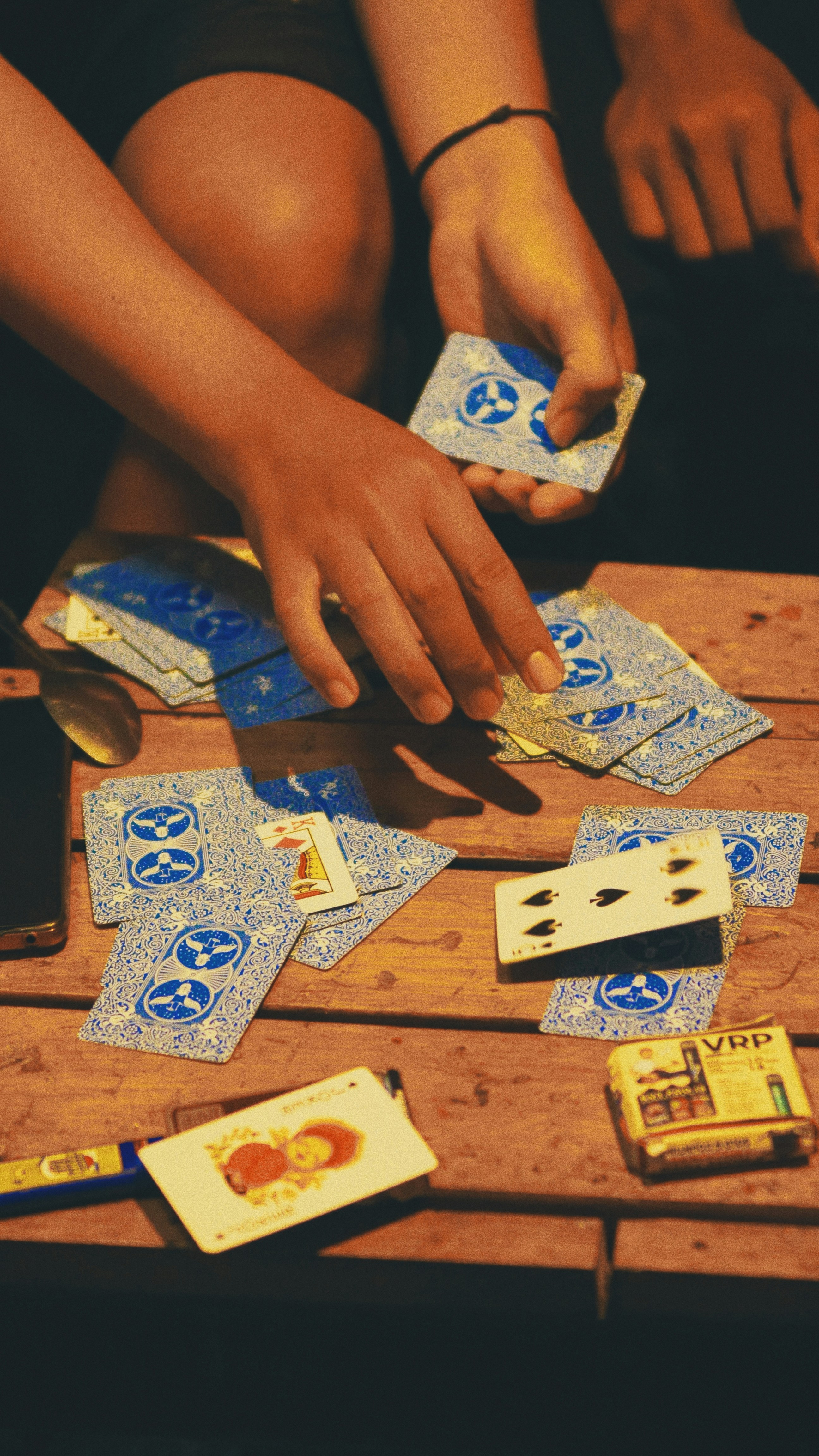 A hand dealing a card for a poker game