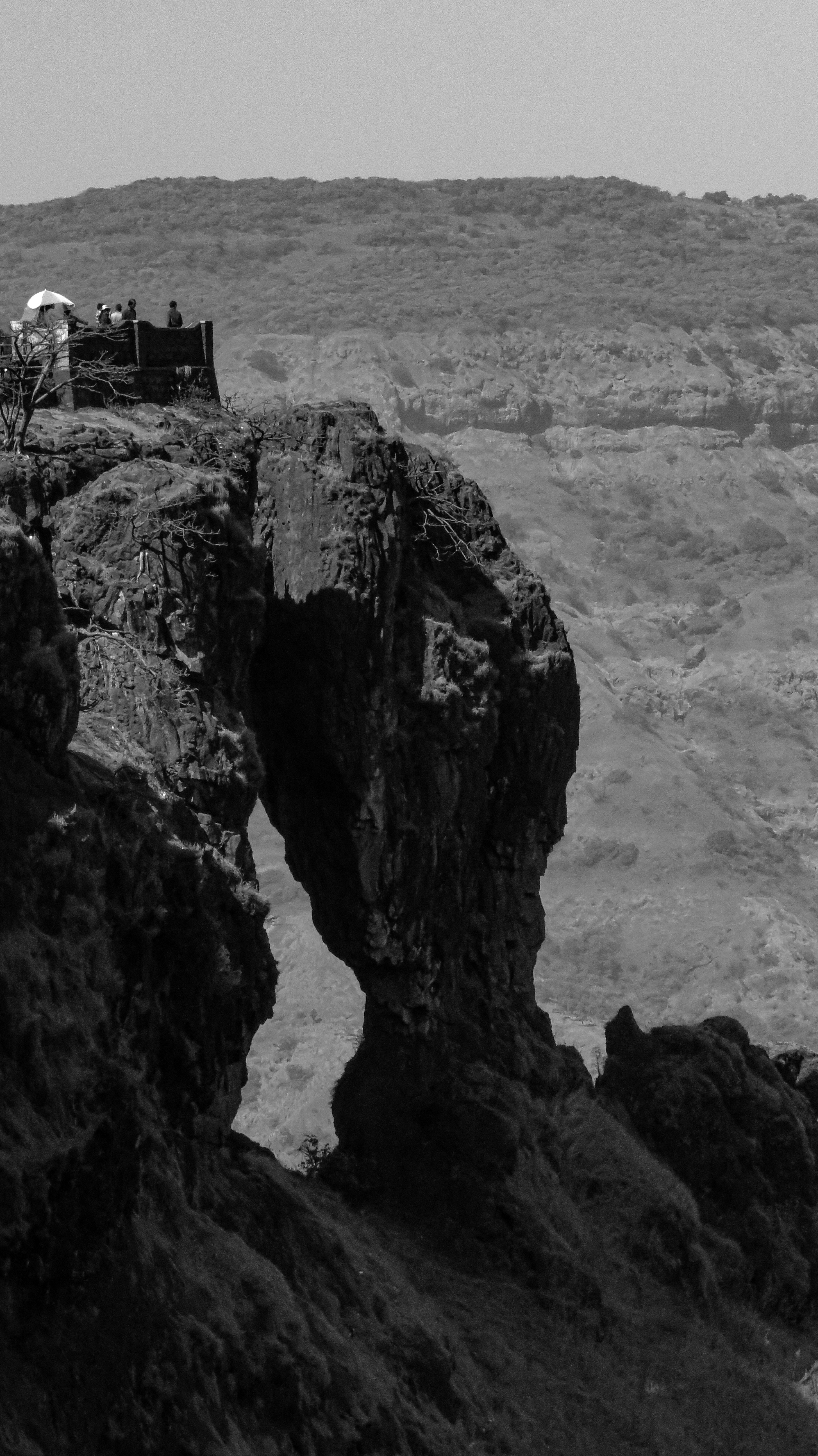 a black and white photo of a rocky cliff