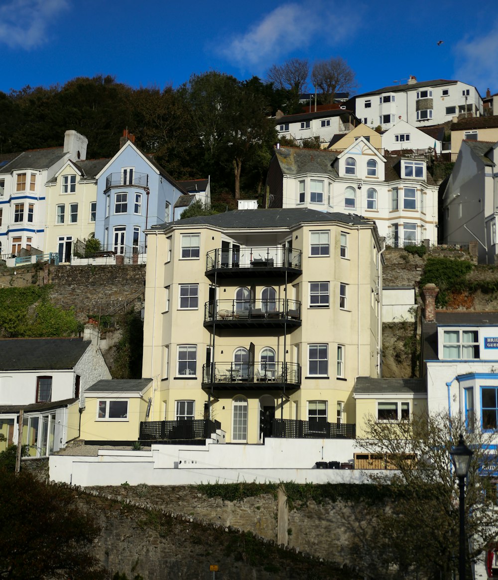a group of houses on a hill with a blue sky in the background