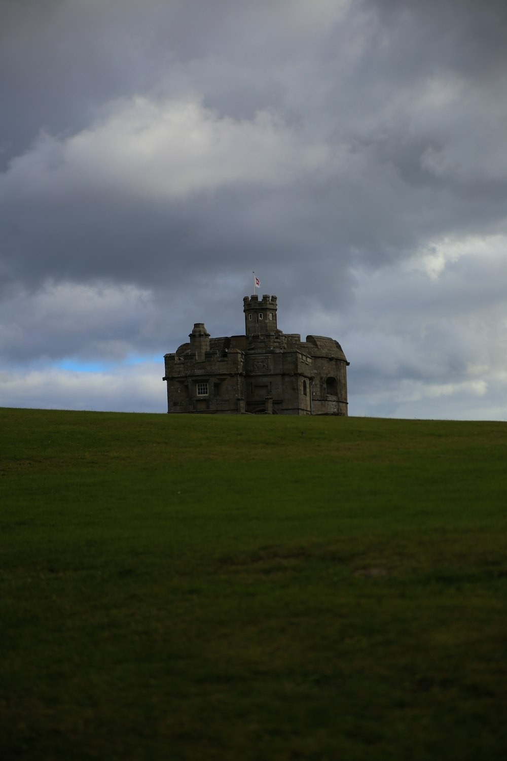 a large building sitting on top of a lush green field