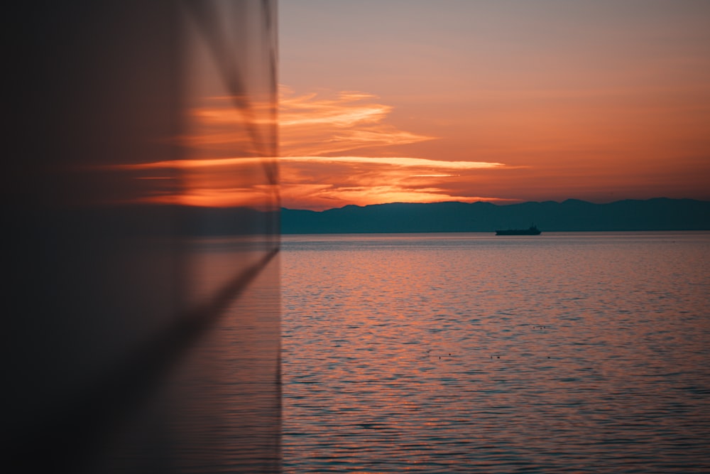 a boat is out on the water at sunset