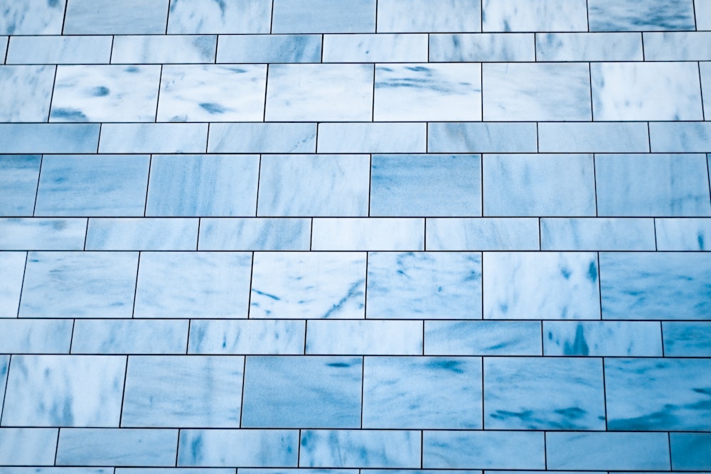 a close up of a blue tiled wall