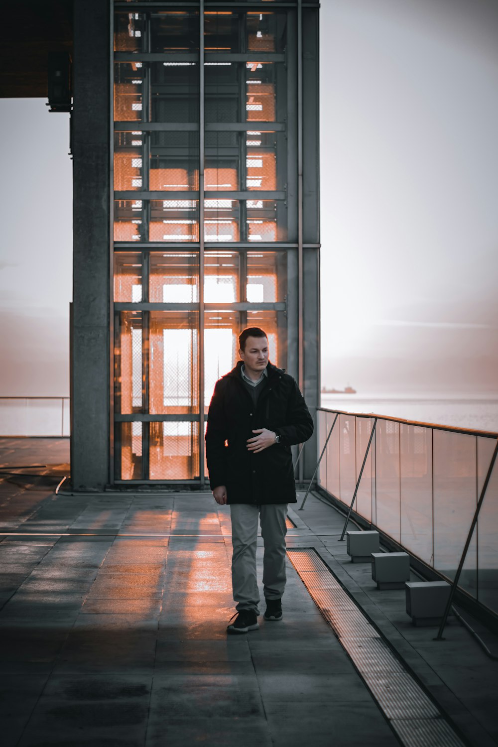 a man standing in front of a tall building