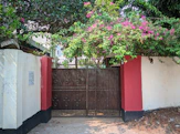a red and white fence with a brown gate