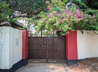 a red and white fence with a brown gate