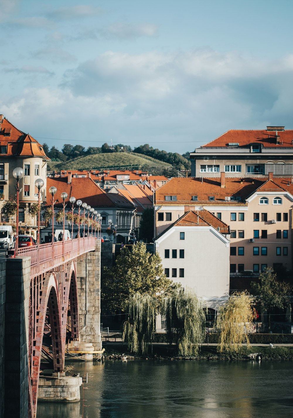 a bridge over a body of water with buildings in the background