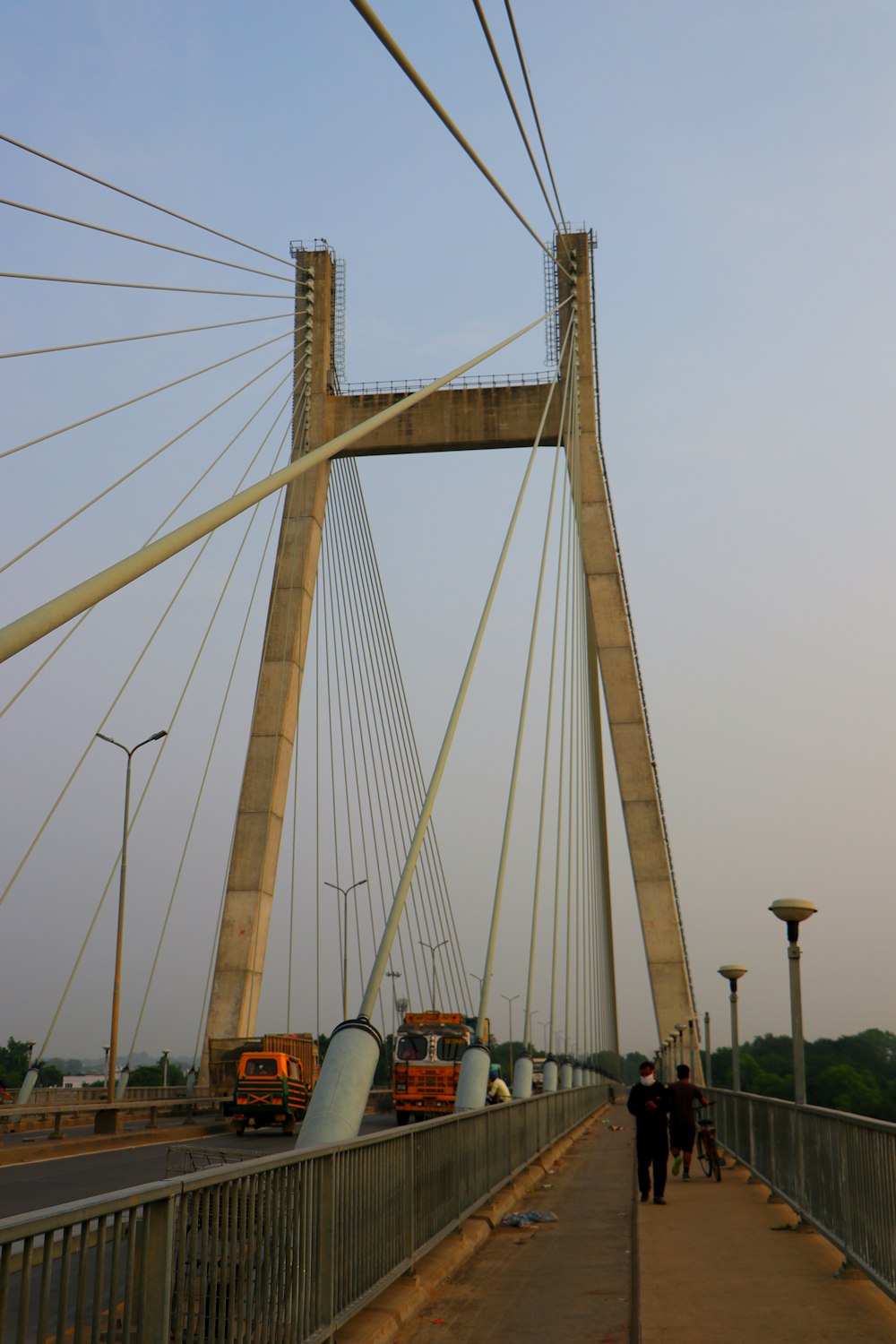 a couple of people walking across a bridge