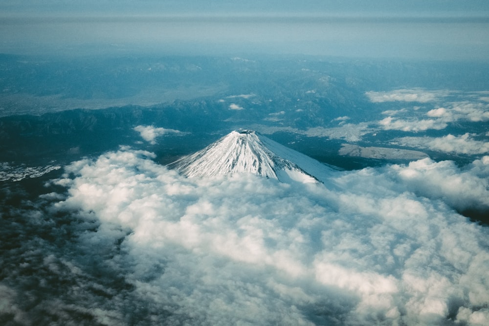 a view of a snow covered mountain from an airplane