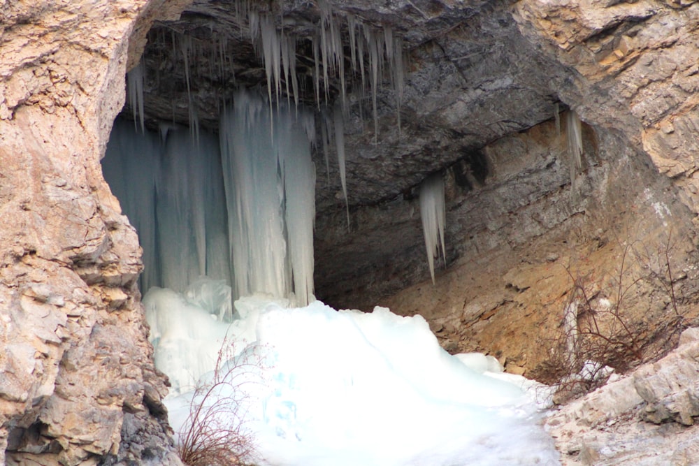 a cave with ice hanging from the side of it