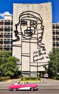 Portrait of Carlos Fonseca with a backdrop of revolutionary symbols and Nicaraguan landscapes.