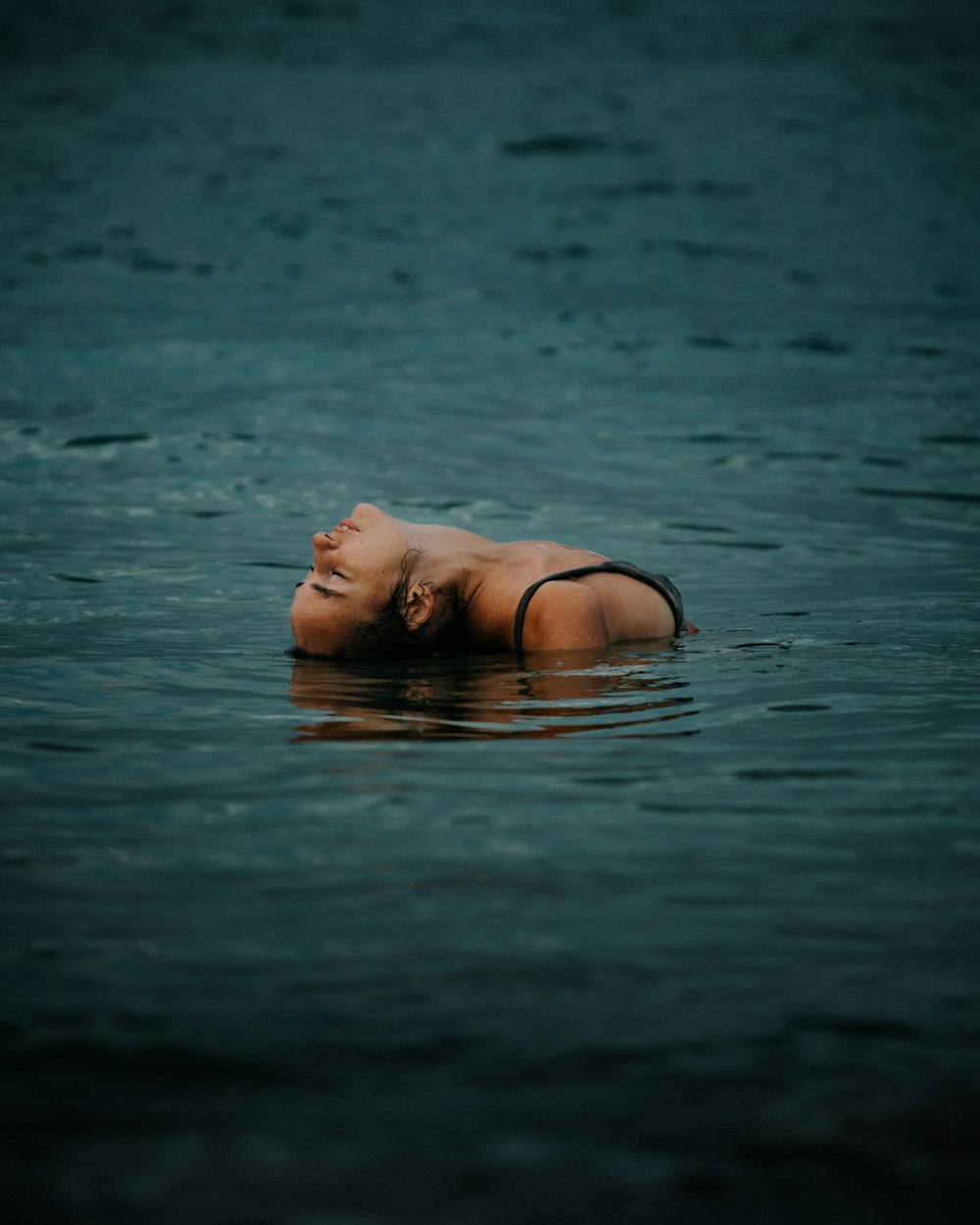 a woman in a bikini floating in the water