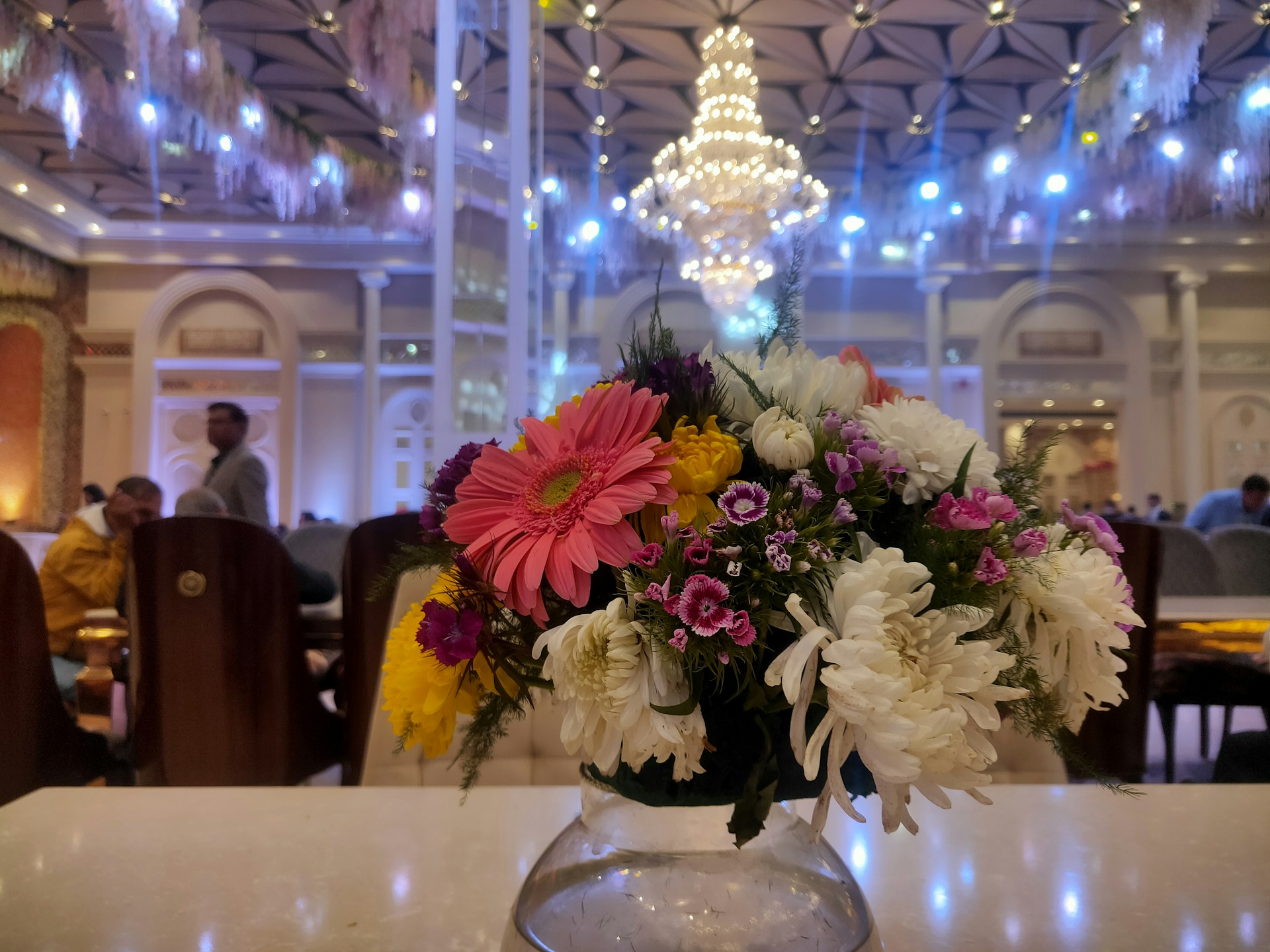 a vase filled with flowers sitting on top of a table
