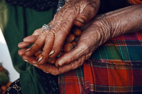 an old woman holding nuts in her hands