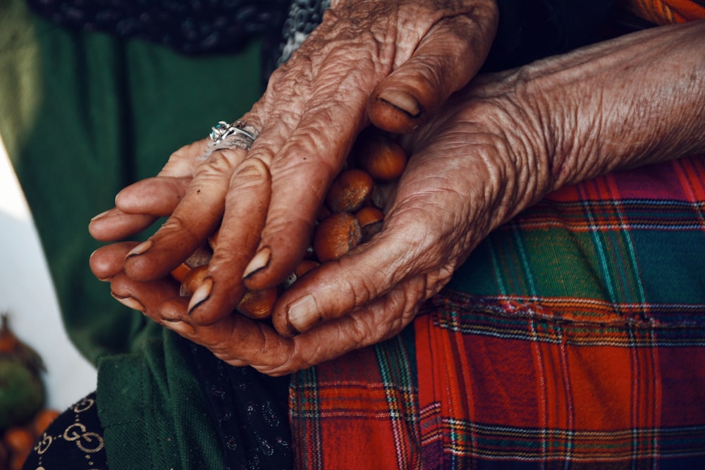 an old woman holding nuts in her hands