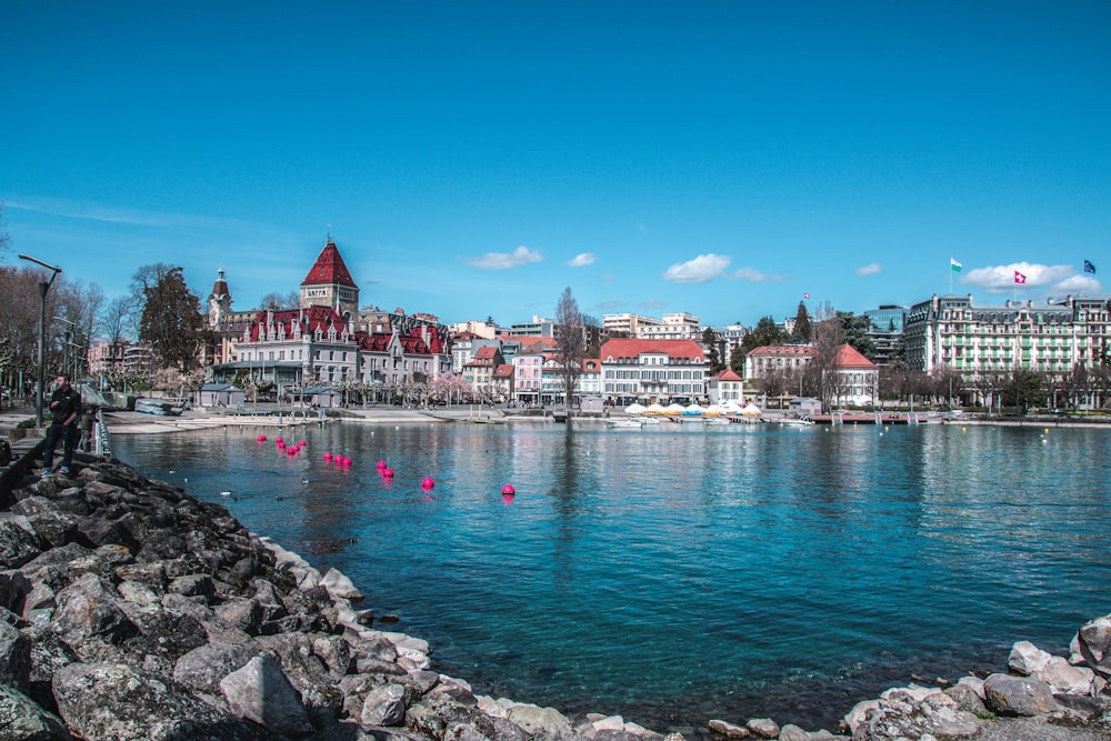 a body of water with a bunch of buildings in the background