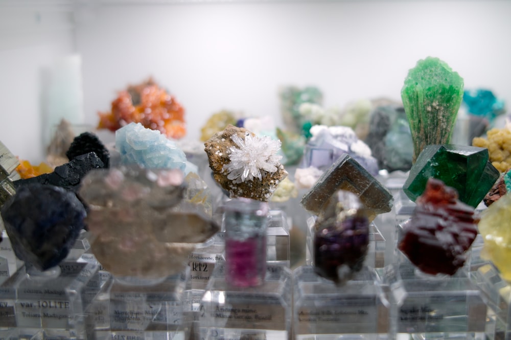 a bunch of different colored rocks on display