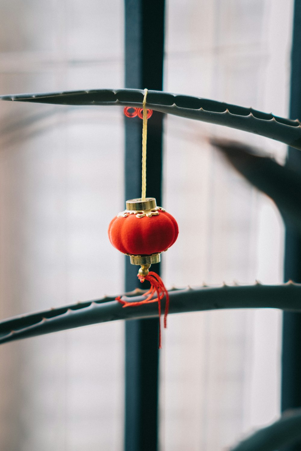 a red object hanging from a metal bar