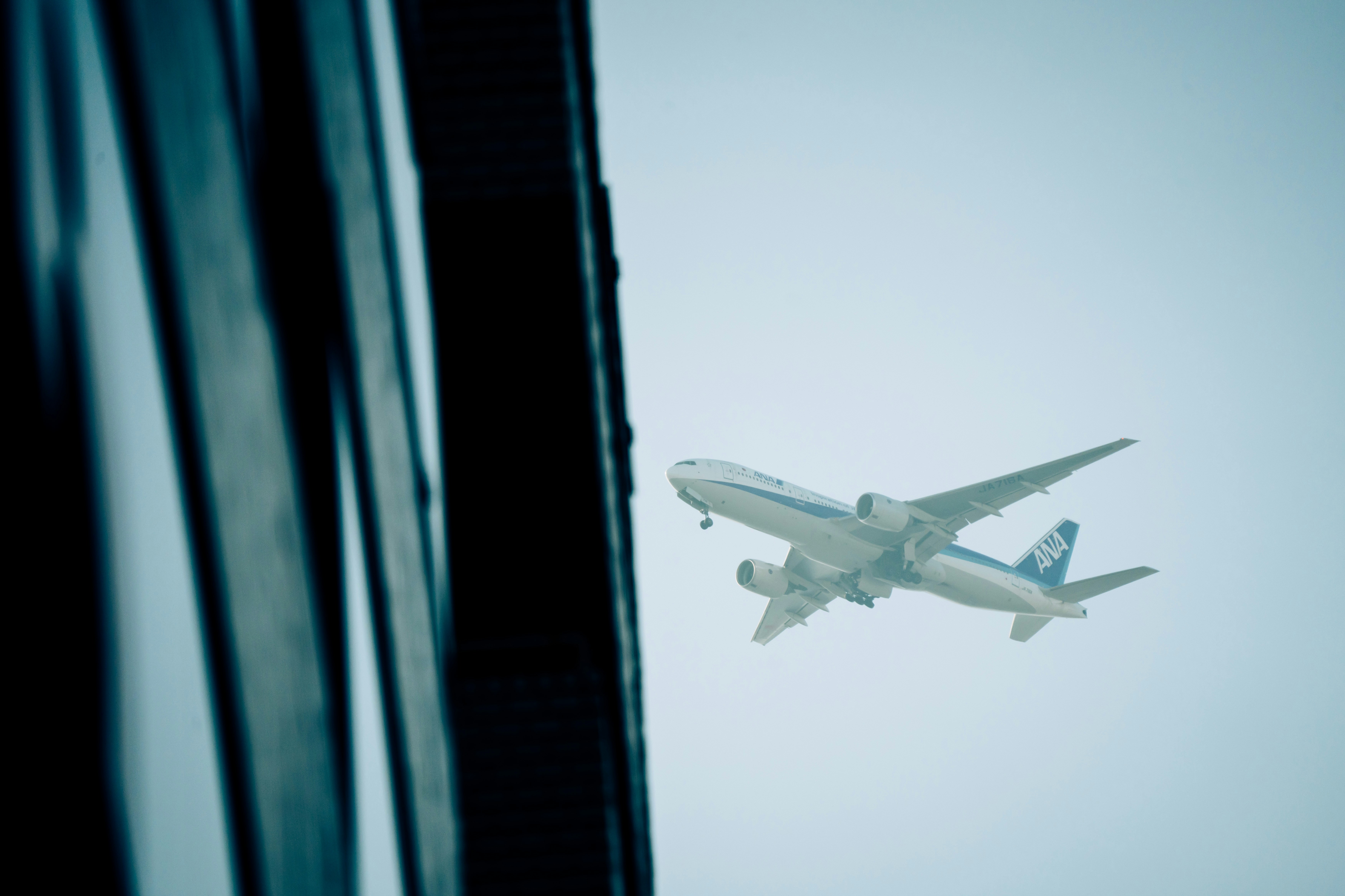 a large passenger jet flying through a blue sky, 