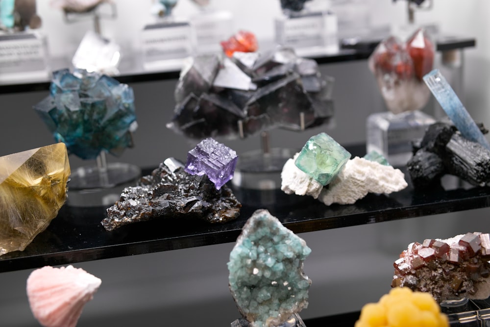 a bunch of different types of rocks on a shelf