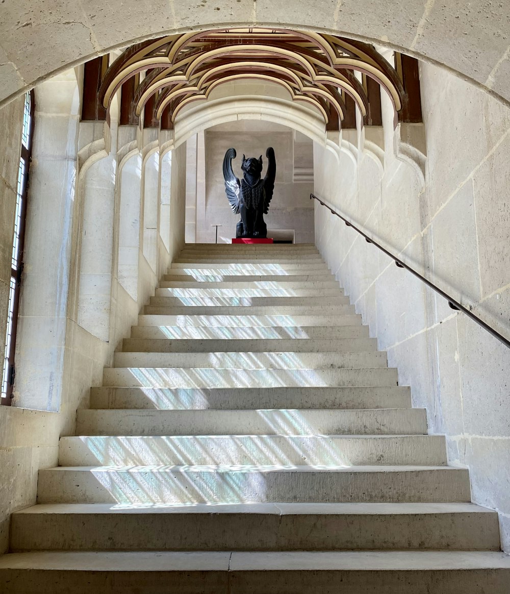 a staircase leading up to a statue in a building