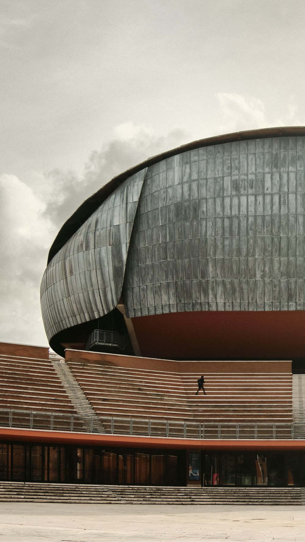 a man is skateboarding in front of a large building