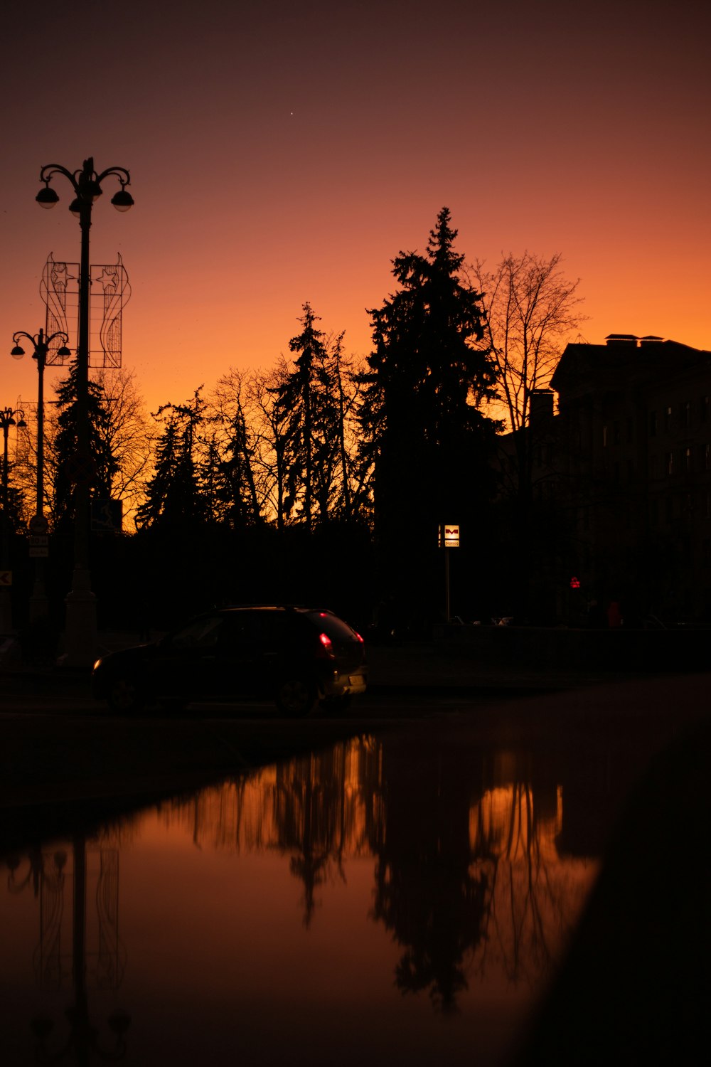 a car is parked in a parking lot at sunset