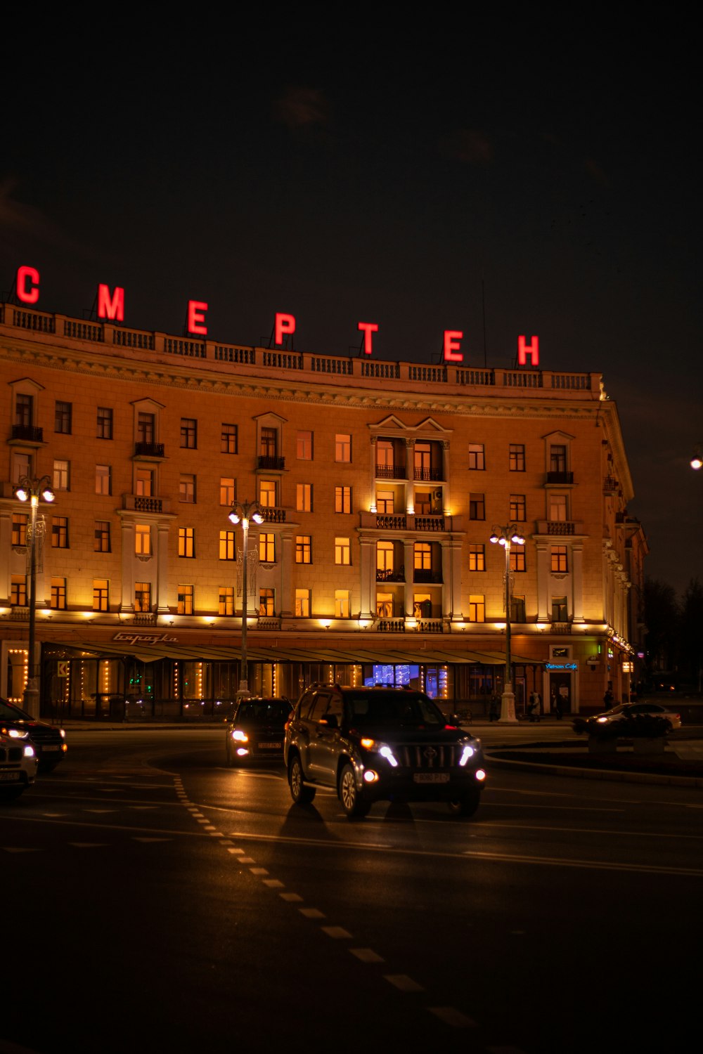 a large building with a neon sign on top of it