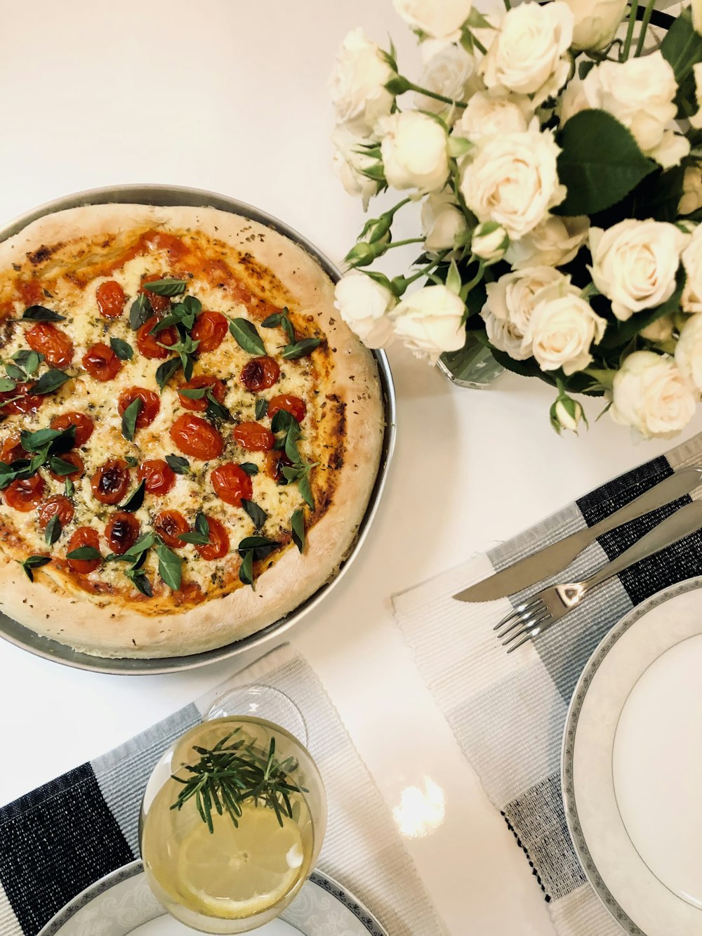 a pizza sitting on top of a pan on top of a table