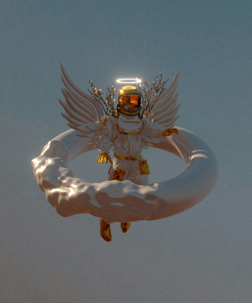 a statue of an angel holding a ring in the sky