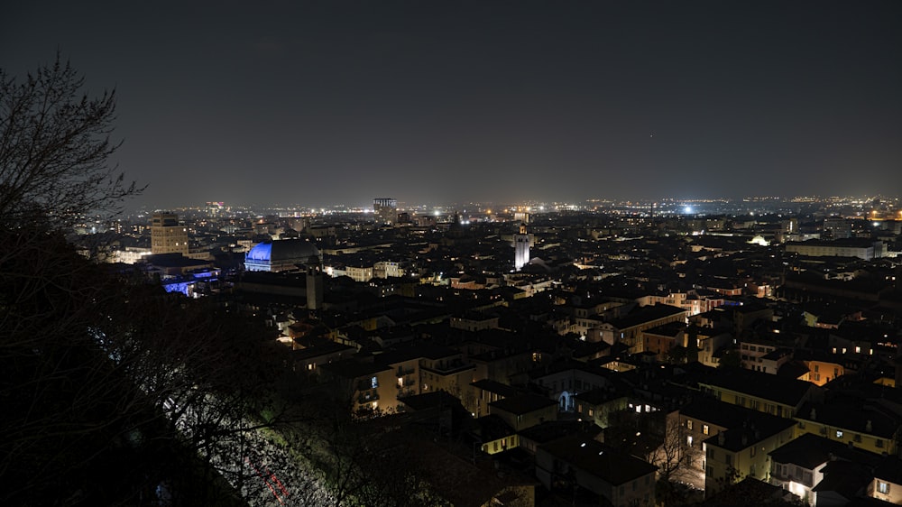 a view of a city at night from the top of a hill