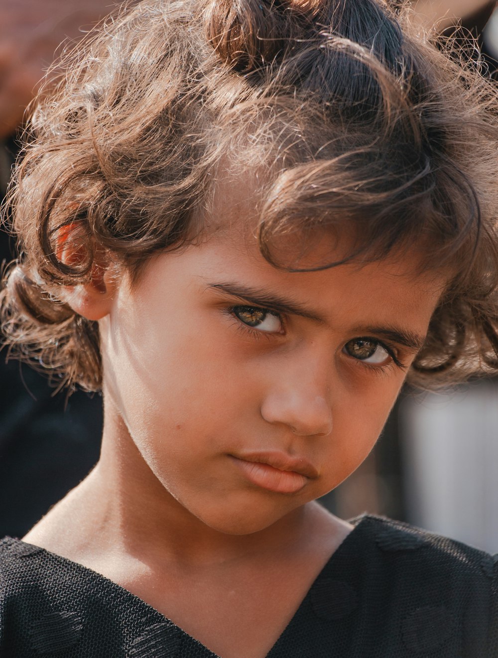 a close up of a young girl with a serious look on her face