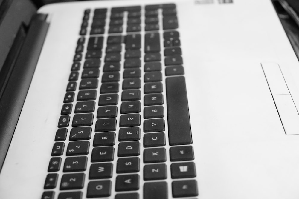 a black and white photo of a laptop keyboard