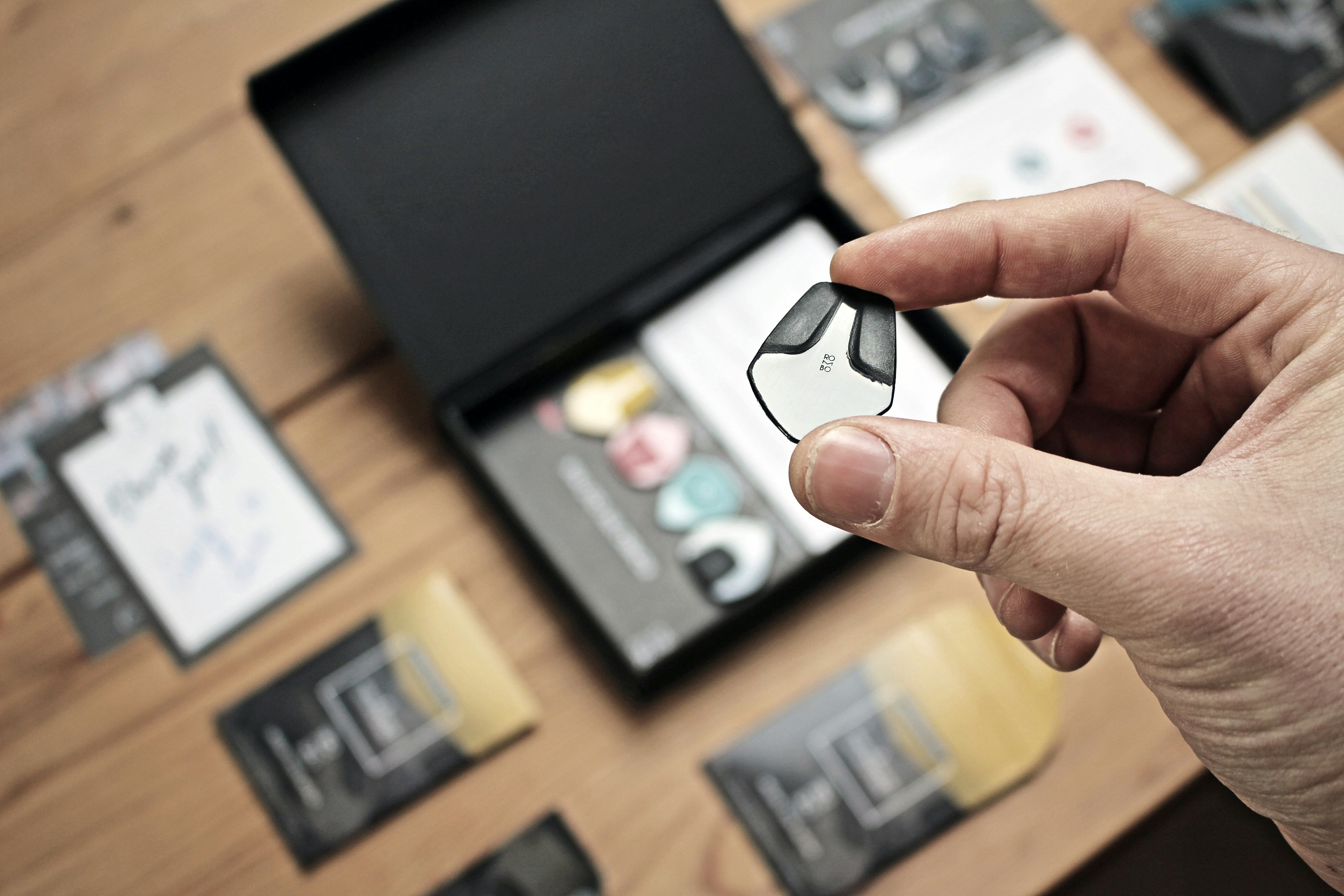 a person holding a small object in their hand