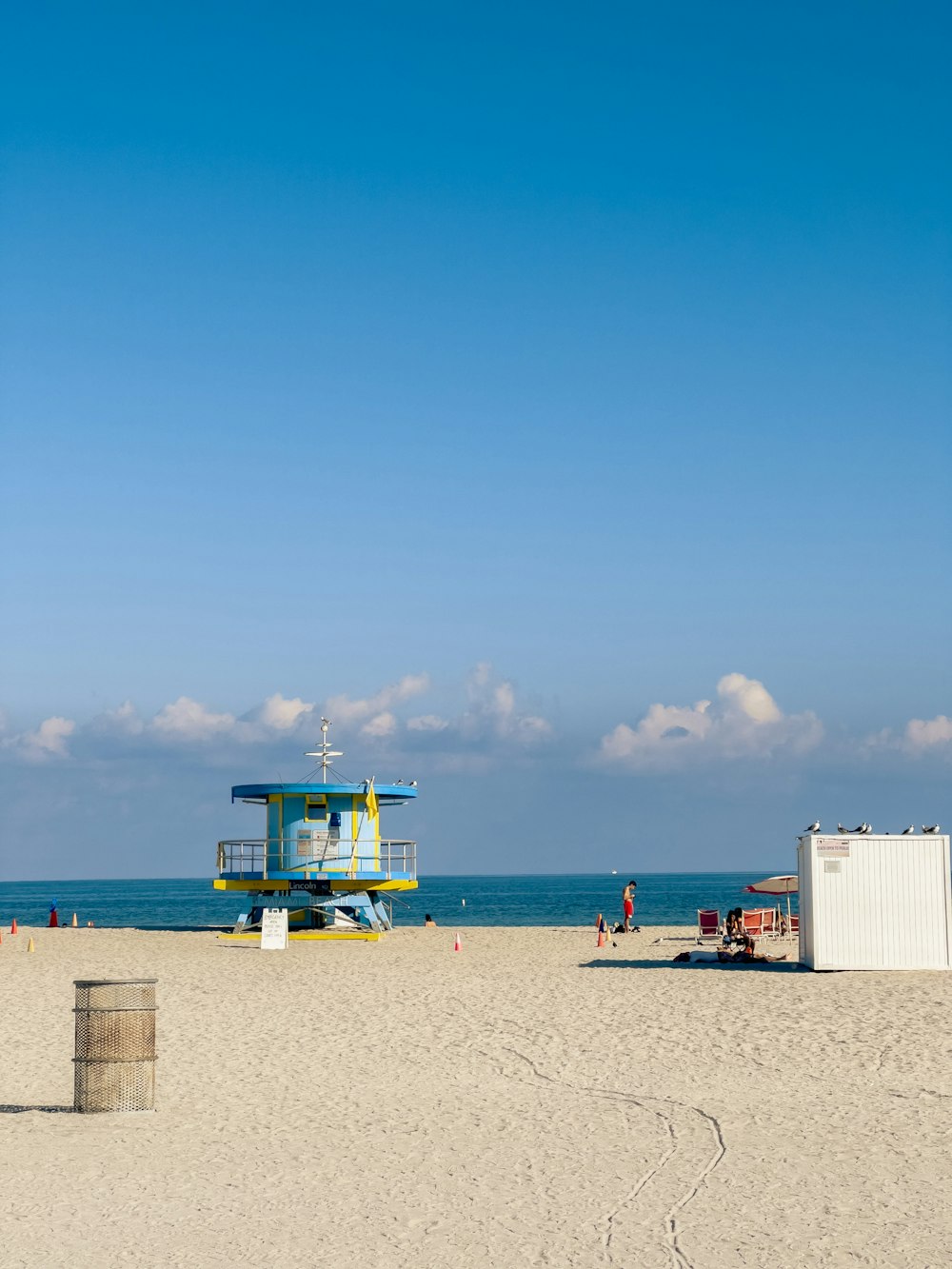a lifeguard station on a beach with a blue sky