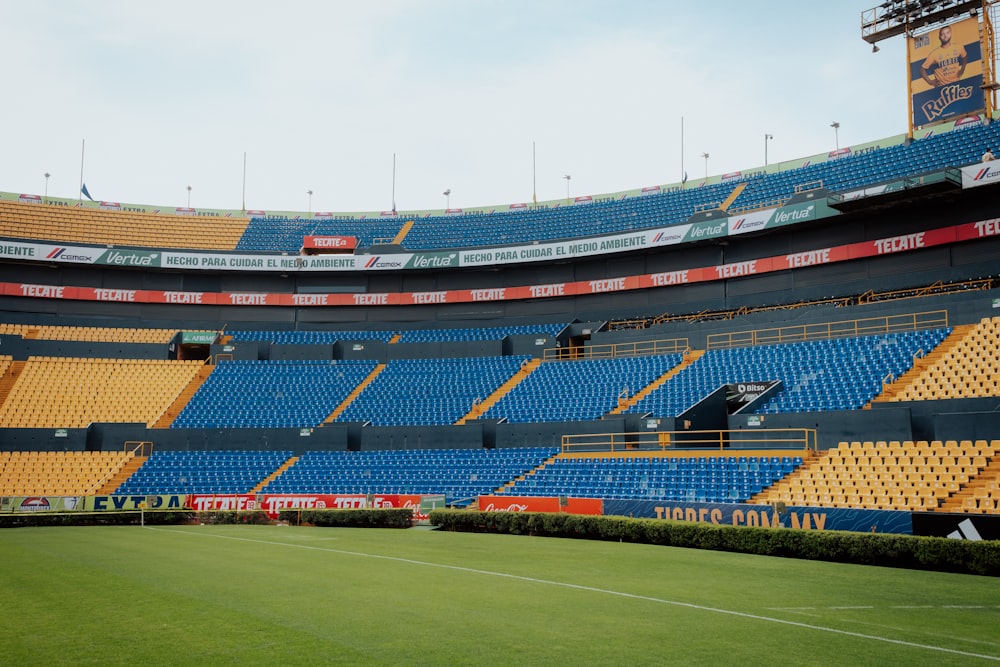 a soccer field with a row of empty bleachers