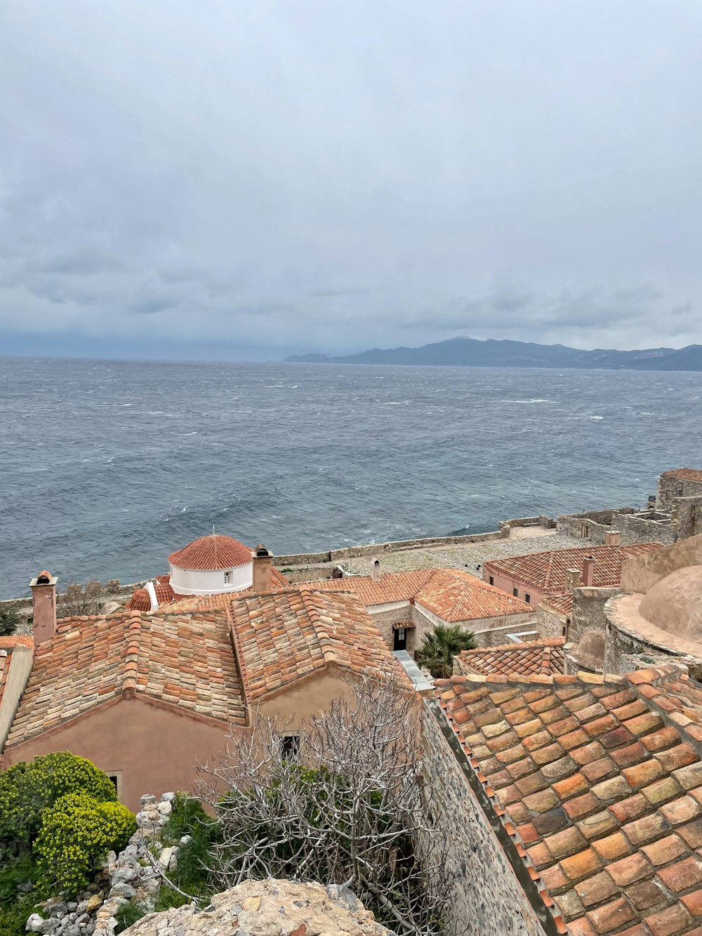 a view of the ocean from a rooftop of a building