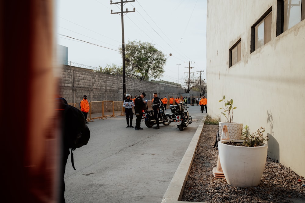 a group of people standing around on motorcycles