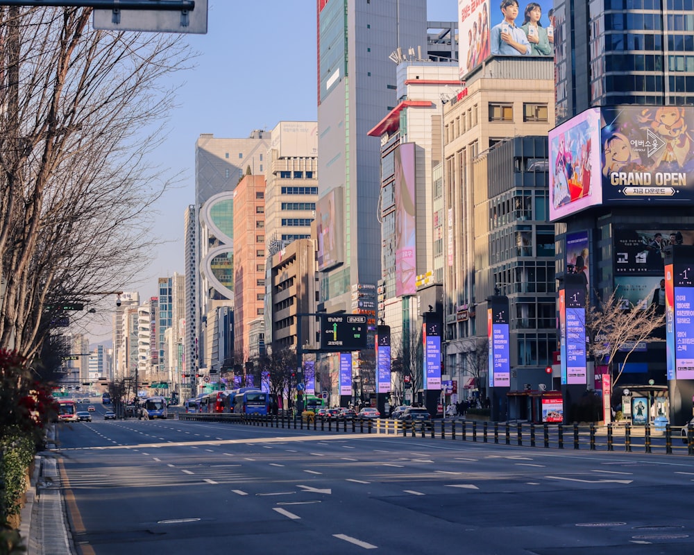a city street lined with tall buildings and billboards