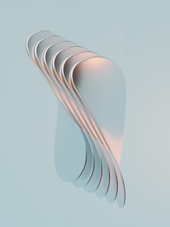 a stack of white plates sitting on top of a blue surface