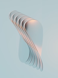 a stack of white plates sitting on top of a blue surface