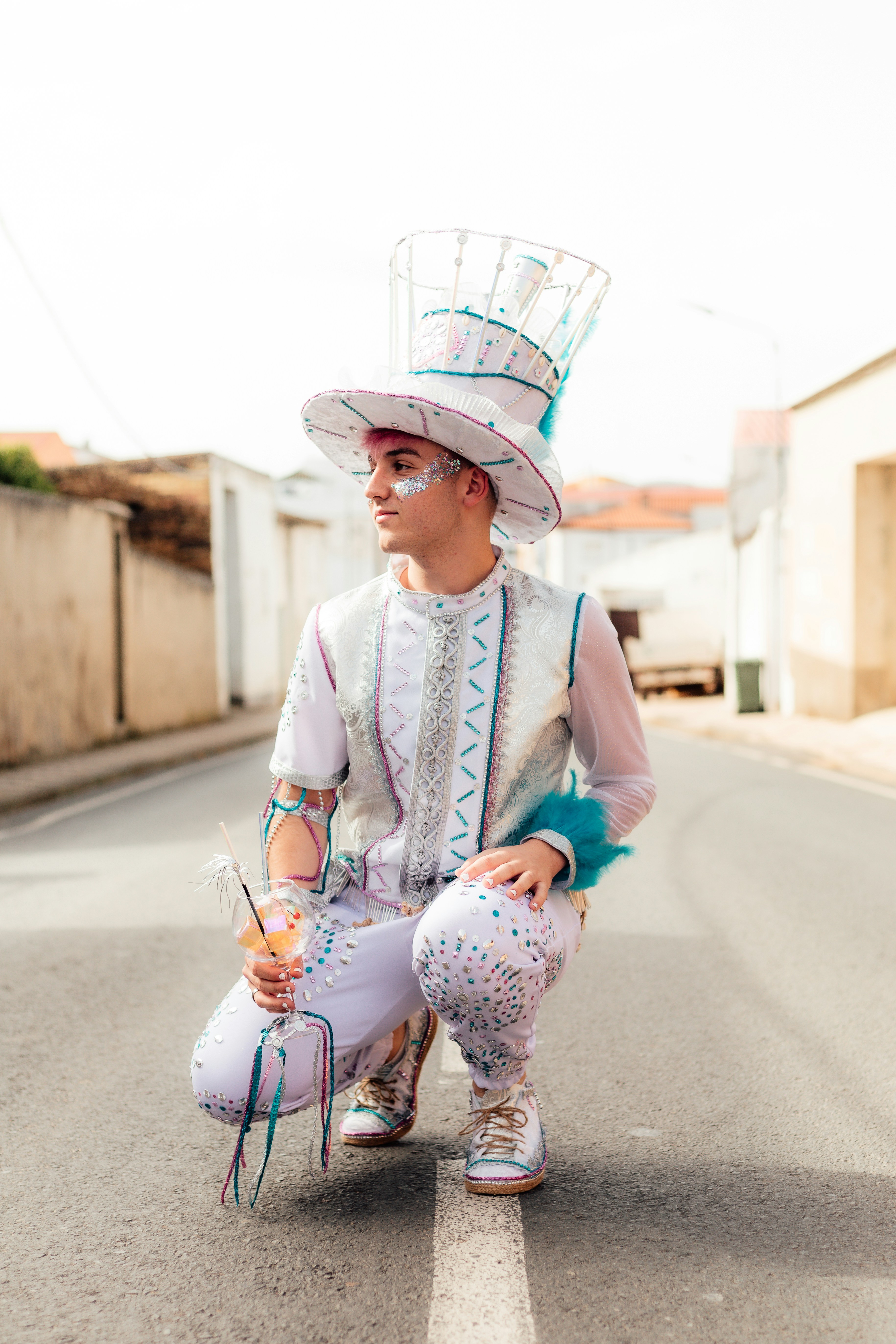 a man in a costume kneeling down on the side of a road
