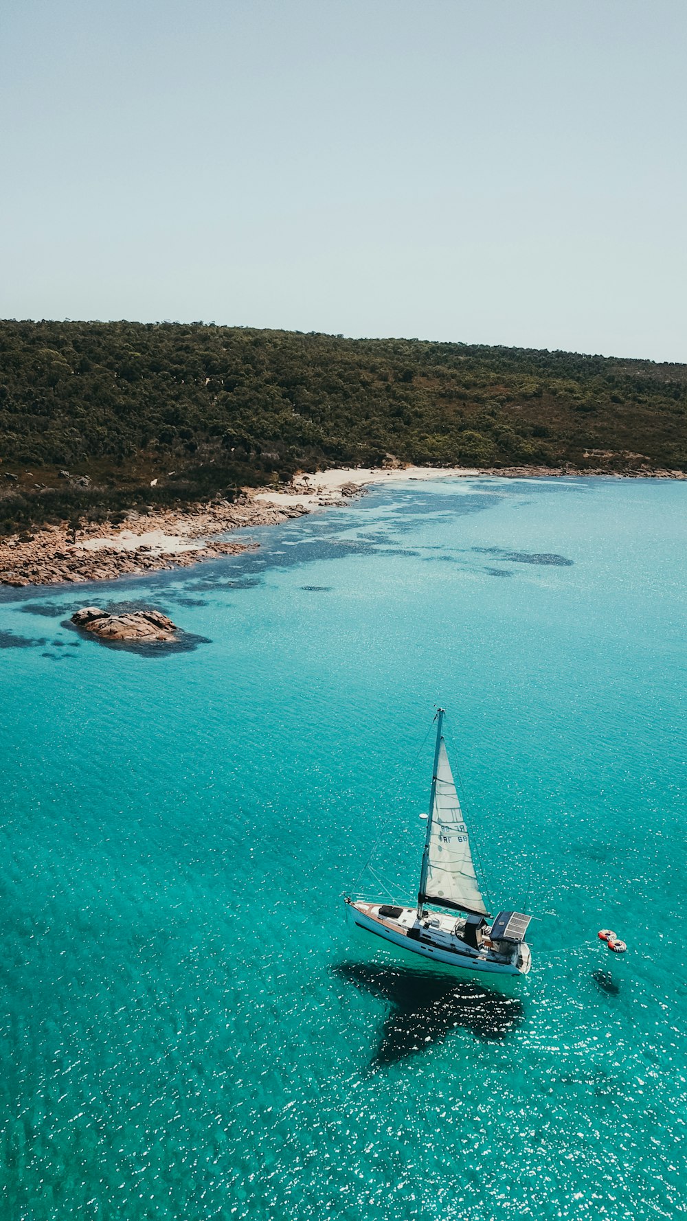 a sailboat floating in the middle of a body of water