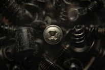 Close-up of hands tightening screws on a modern metal furniture frame.