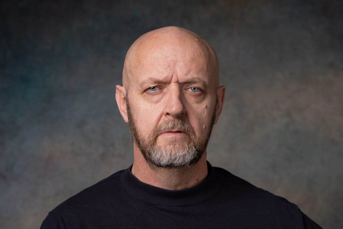 a man with a bald head wearing a black shirt