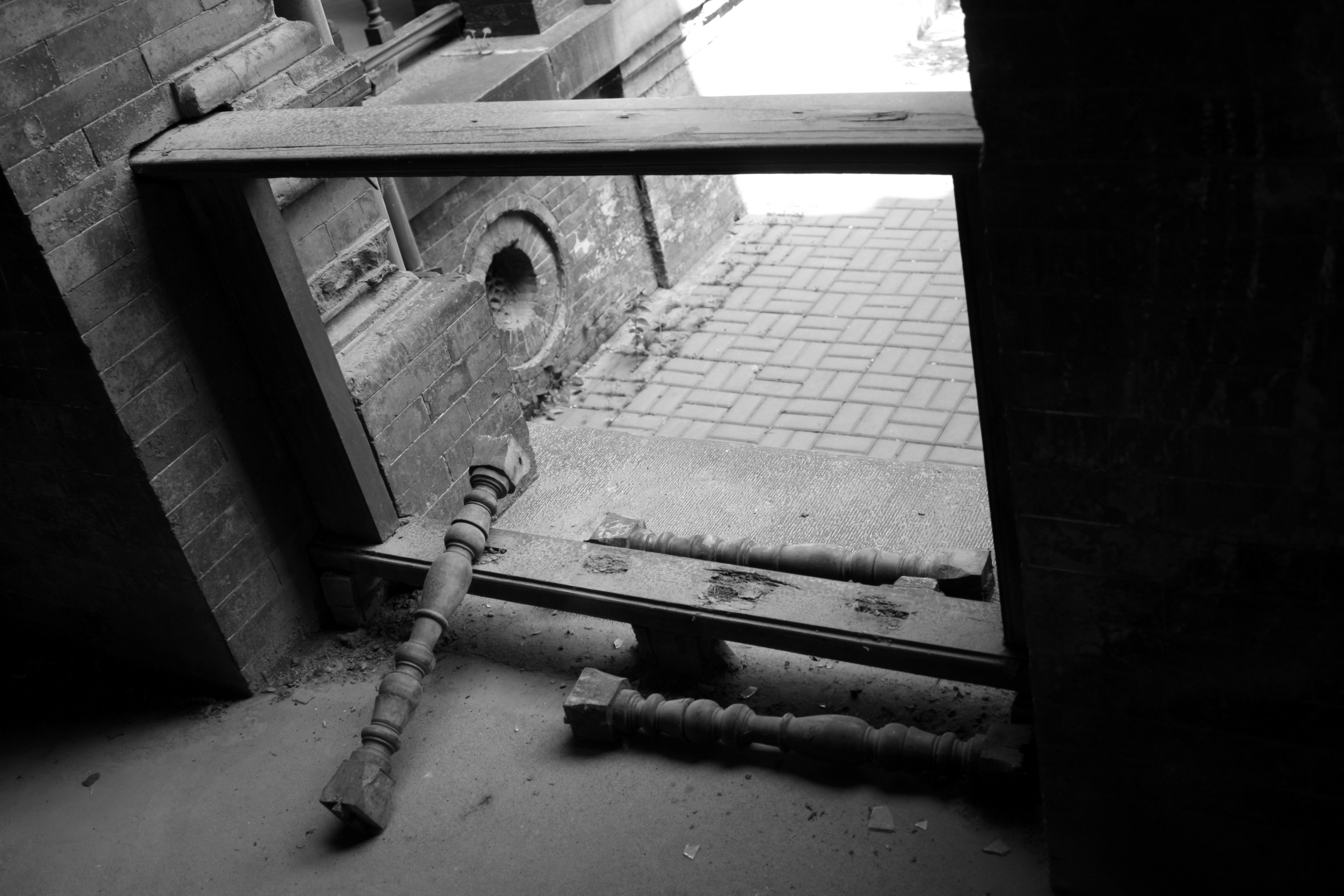 A pipe sticking out of the ground next to a building photo Free